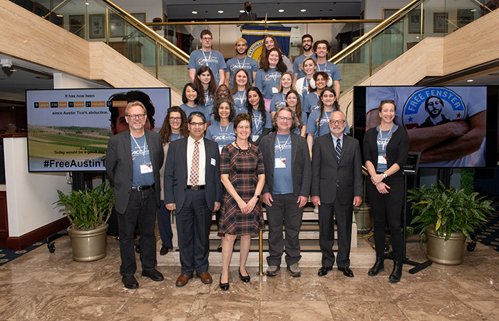 The group from Syracuse poses for a group photo.